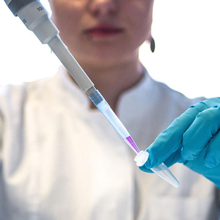 student in the lab with a pipette